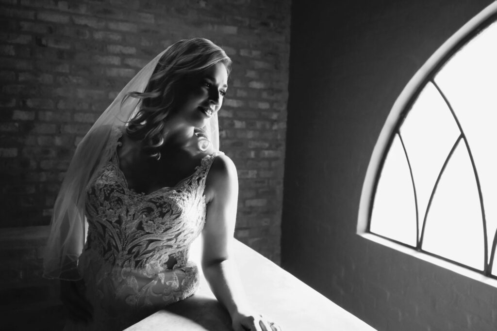 Bride posed by wedding photographer River side castle bride